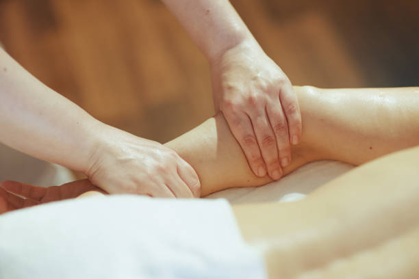 istock Massage therapist in massage cabinet massaging clients arm 1650570239
