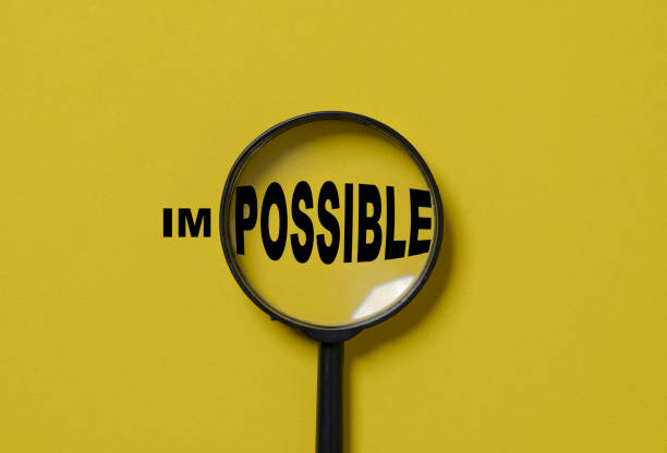 istock Magnifier glass focusing to possible from impossible wording on yellow background , Positive thinking mindset and human inspiration development concept. 1650593281