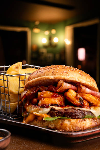 istock surf and turf hamburger with shrimp beef burger accompanied by rustic fries 1650603033