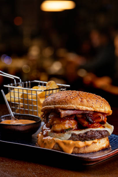 istock surf and turf burger with melted beef cheddar burger shrimp with cheddar sauce blurred background 1650603070