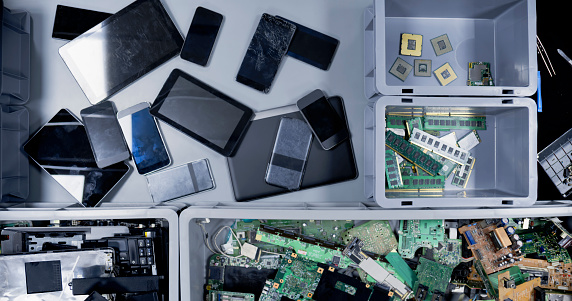 Overhead view of mobile phones and digital tablets on desk.