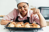 Frustrated female pastry chef looking at some bread