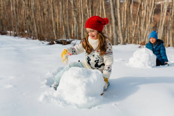istock Playful children rolling snowball for Snowman 1650626149