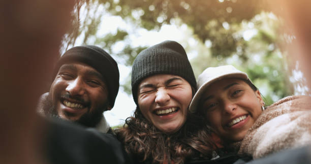 Friends, face or hikers taking a selfie while hiking outdoors in nature sharing the experience on social media. Winter, portrait or happy people take a picture or a photo while trekking together