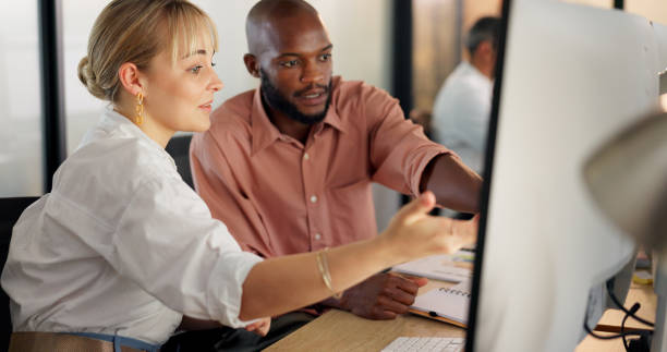 istock Teamwork, human resources and training with a business woman explaining to an intern working in an office. Marketing, computer and collaboration with a male and female employee team at work together 1650639859
