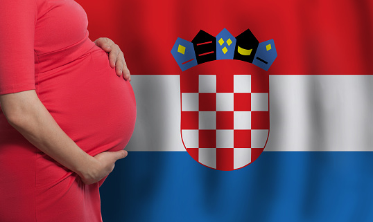 Croatian pregnant woman belly on flag of Croatia background