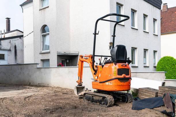 istock Small crawler excavator at a construction site near a residential building. 1650659493
