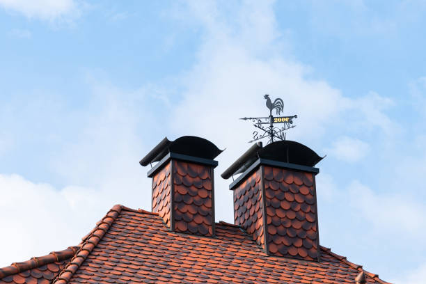 metal vane with a rooster and the date of erection on the chimney of the house. - roof roof tile rooster weather vane imagens e fotografias de stock