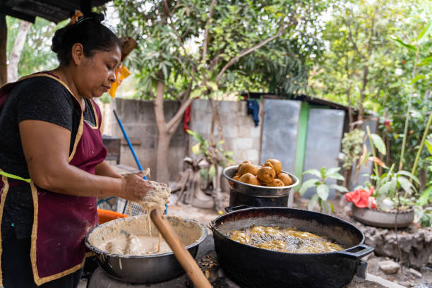 istock Latin woman preparing food on an outdoors rural kitchen 1650662199