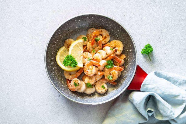 istock Frying shrimps with lemon in the frying pan. 1650671541