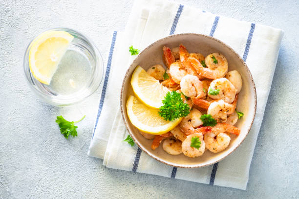 istock Frying shrimps with lemon in the bawl. 1650671564