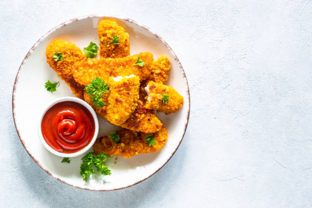 istock Chicken nuggets with ketchup sauce. 1650674905