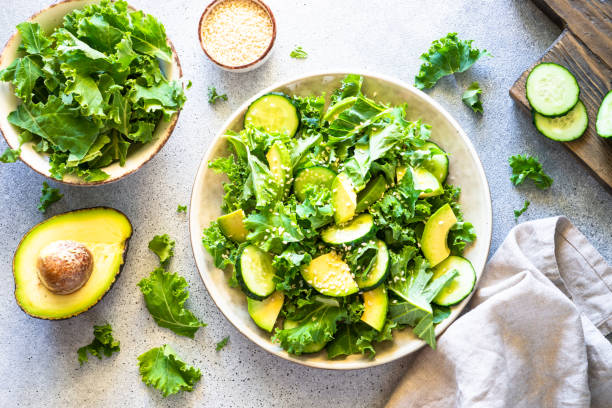 istock Kale salad leaves in craft plate top view. 1650675031