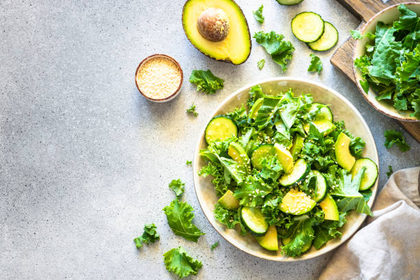 istock Kale salad leaves in craft plate top view. 1650675085