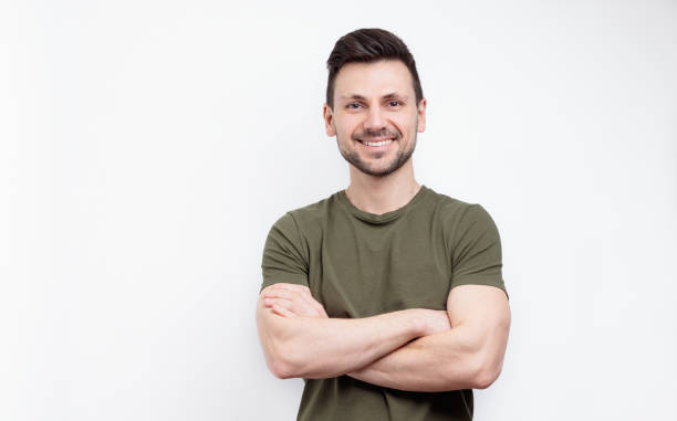 istock Smiling man with crossed arms over white background 1650675659