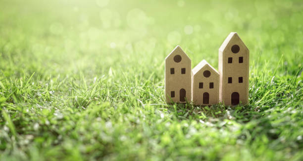 istock Ecological cardboard  model house in empty field at sunset 1650675678