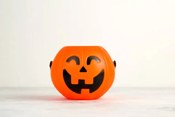 Photo of Jack O' Lantern Halloween pumpkin empy candy bowl Trick or treat concept
