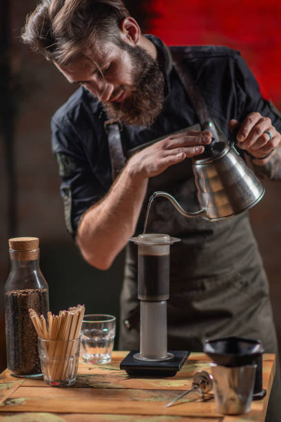 istock Expert Barista Crafting Coffee with Aeropress coffee maker 1650677783