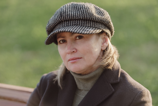 Middle age woman in warm coat and hat outdoors