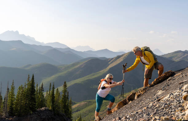 istock Senior couple explore mountain slope 1650682675