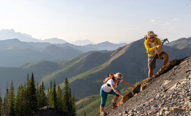 istock Senior couple explore mountain slope 1650682686
