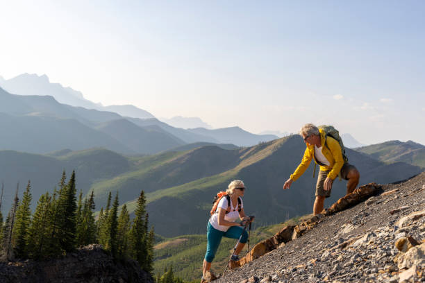 istock Senior couple explore mountain slope 1650682697