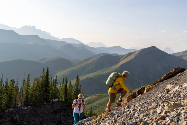 istock Senior couple explore mountain slope 1650682709