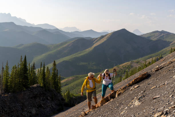 istock Senior couple explore mountain slope 1650683269