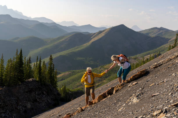istock Senior couple explore mountain slope 1650683280
