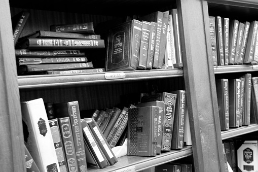 Jerusalem, Israel - May 5, 2018 Jewish sacred books Torah on bookshelf library for prayer at synagogue. Books Torah from wooden bookcase in Hebrew library. Retro book Rack Torah off islamic library