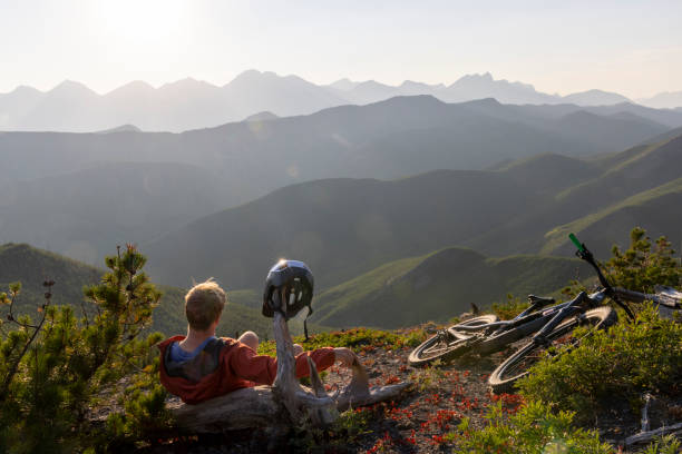 istock Male mountain biker relaxes on mountain ridge 1650683841