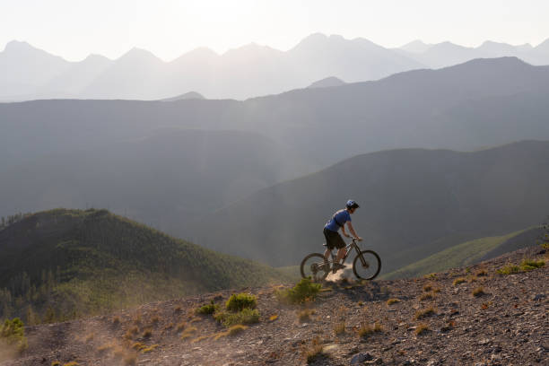 istock Male mountain biker rides down mountain 1650683919