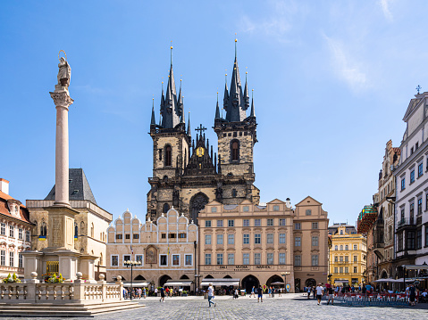 Prague, Czech Republic - 27 June 2022: Sunny daytime view of the Marian column and the Church of Mother of God before Týn, Old Town Square, Prague