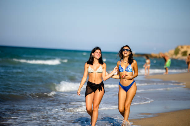 istock Two pretty young woman having fun on the seaside 1650749111
