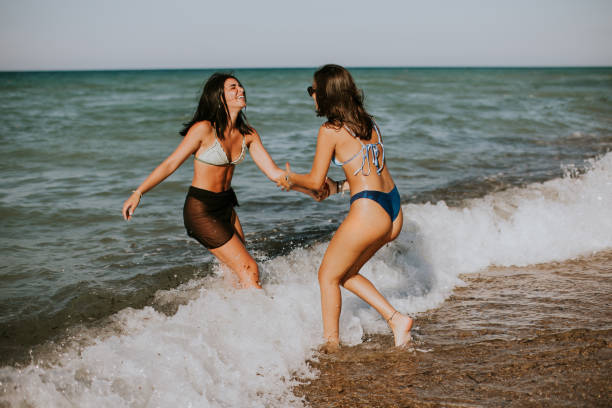 istock Two pretty young woman having fun on the seaside 1650749114