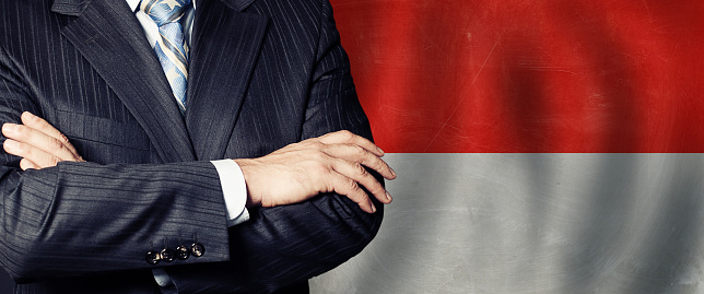 Male hands against red and white flag background, business, politics and education in concept