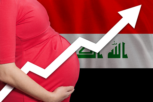 Iraqi pregnant woman on flag of Iraq background. Birth rate up