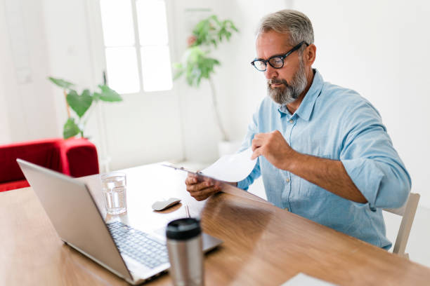 istock Concentrated senior businessman working at office 1650767336
