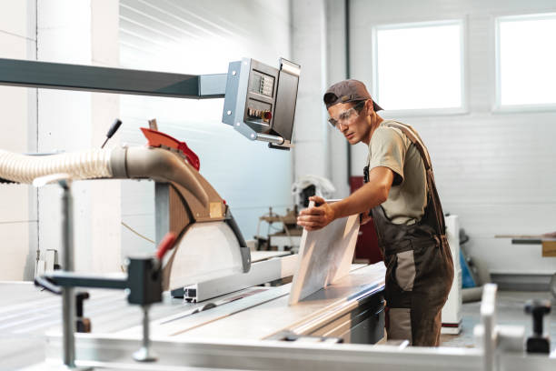istock Male carpenter using some woodworking tools for his work in a factory 1650771915