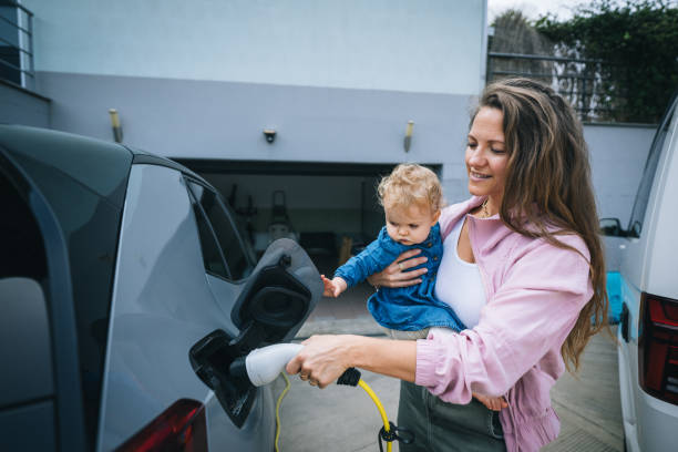istock Mother and infant charge electric vehicle 1650772393