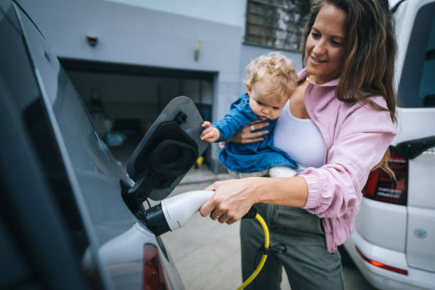 istock Mother and infant charge electric vehicle 1650774443