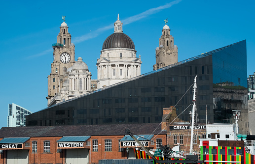 Liverpool skyline from the Strand Street St in England UK United Kingdom, and the water reflection on the Canning Dock in a sunny summer blue sky day.