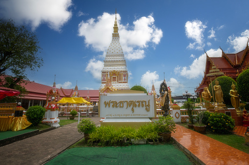 Beautiful white pagoda at Wat Phrathat Renu Nakhon, Nakhon Phanom Province Thailand. Phrathat Renu Nakhon sign name in Thai language.