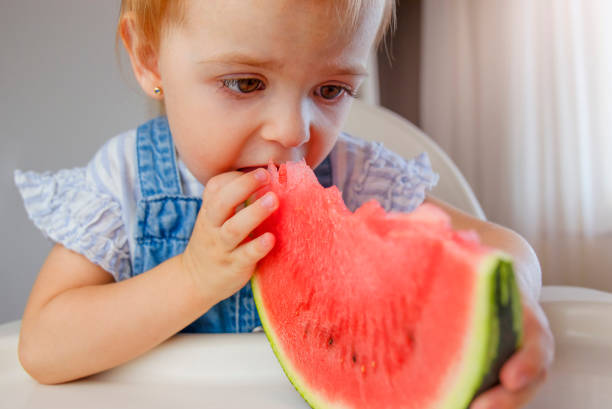 istock Little child eating watermelon 1650816049
