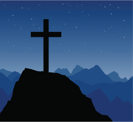 A cross on a mountain peak on a beautiful night.