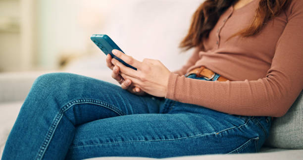 istock Sofa, home and hands typing on smartphone chat, social media or networking connection on mobile app, internet or house wifi. Teenager girl or woman with cellphone technology texting message in lounge 1650824986