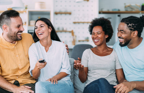 istock Cheerful friends watching TV at home. 1650830521