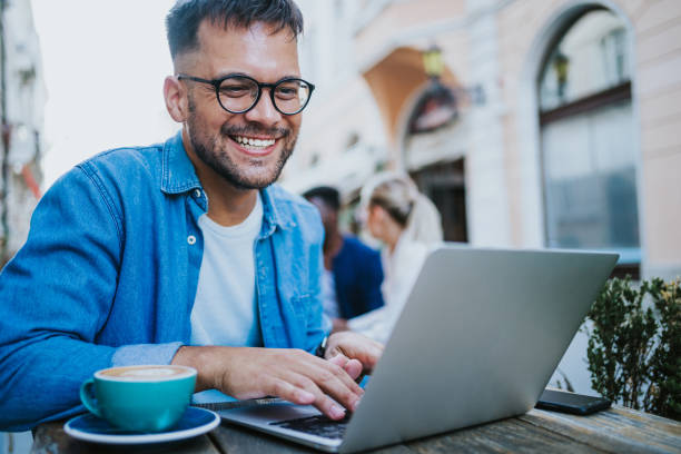 istock Young man sitting in coffee shop and using laptop. 1650831050
