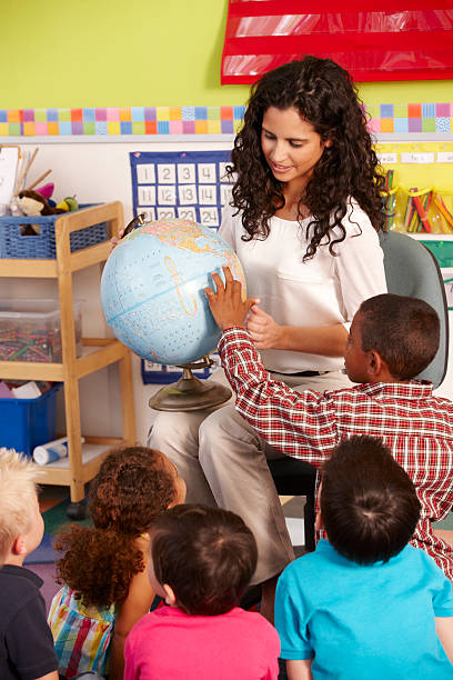 istock Group Of Elementary Age Schoolchildren In Class With Teacher 165084495