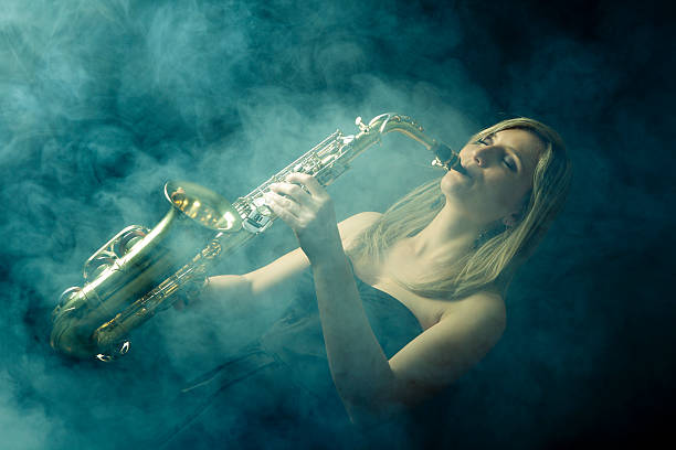 istock Beautiful woman playing saxophone 165085237